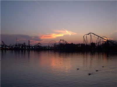 Picture Of Carousels At Amusement Park At Dusk